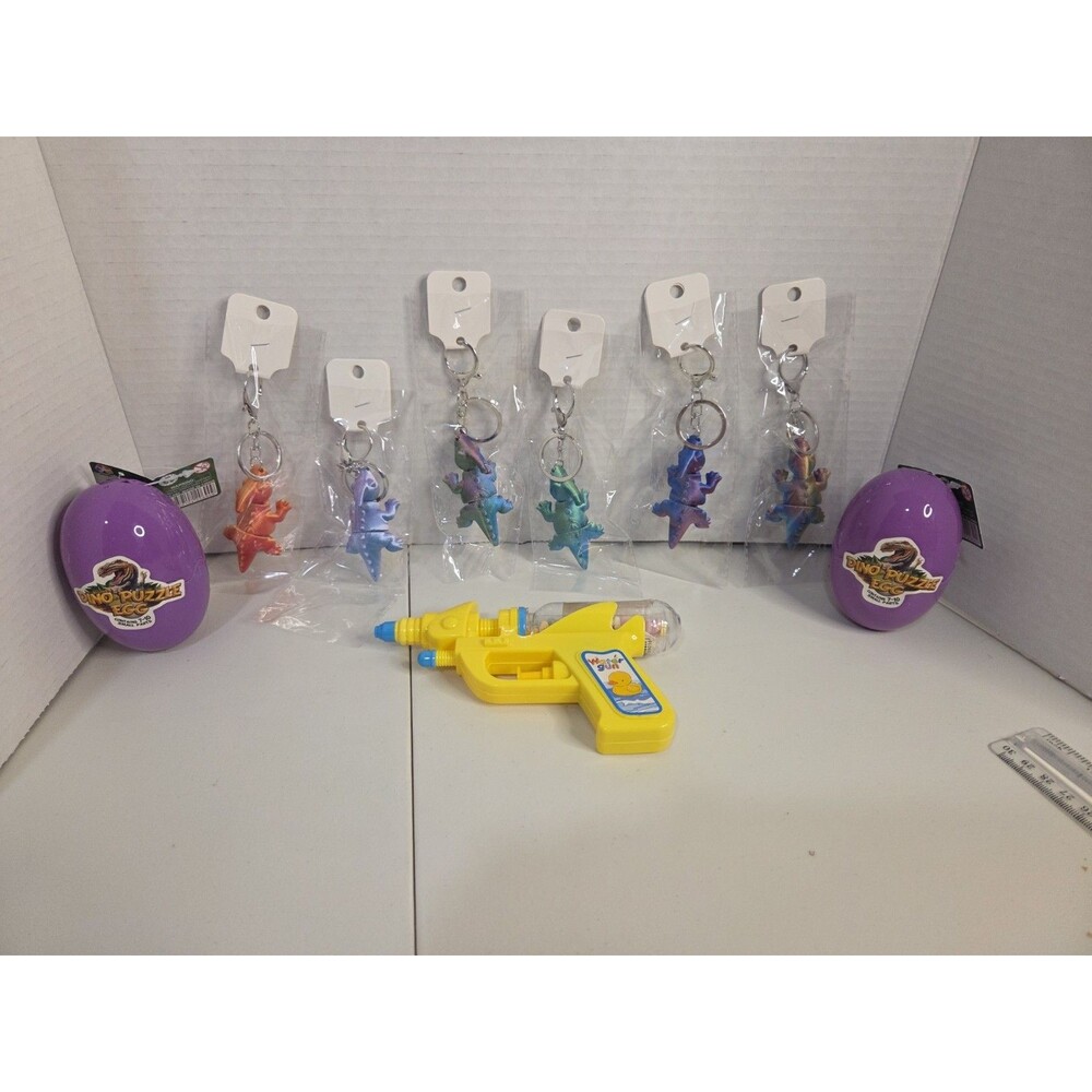 Lot of 6 Dinosaur Keychains, + Yellow Water Gun + 2 dinosaur puzzle eggs